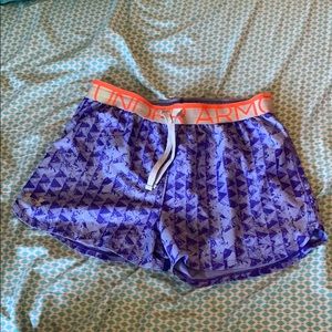 two pairs of under armor activity shorts